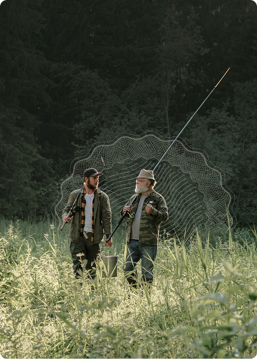 Two men in a field discussing plans